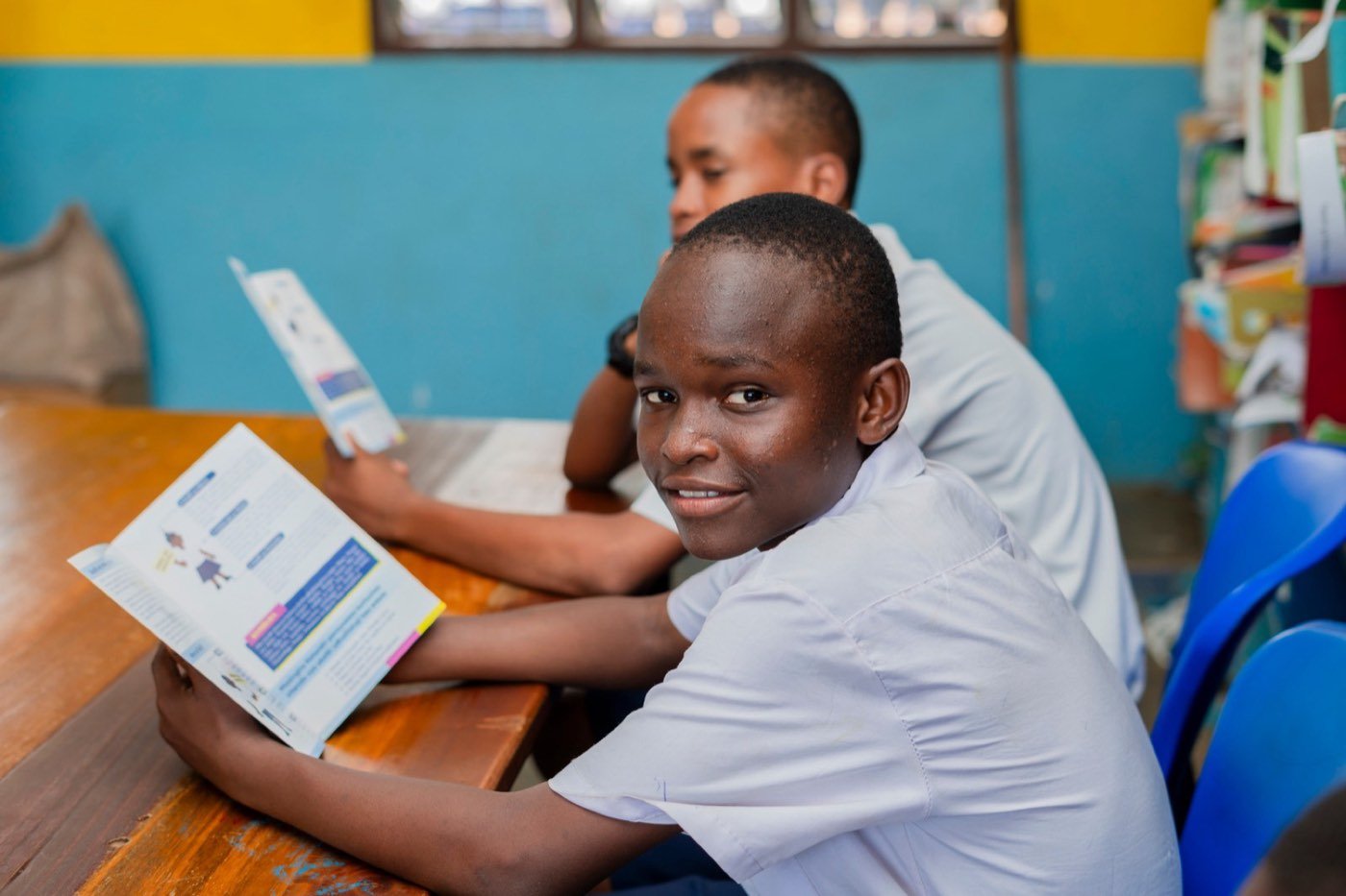 A student reading a learning booklet in class